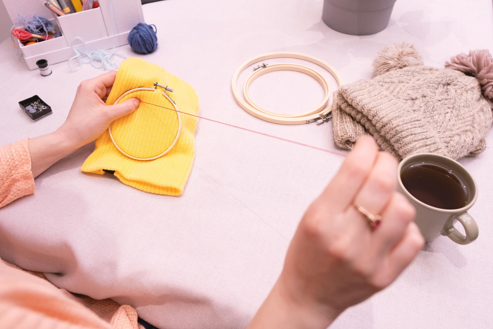 Student working at an embroidery hoop